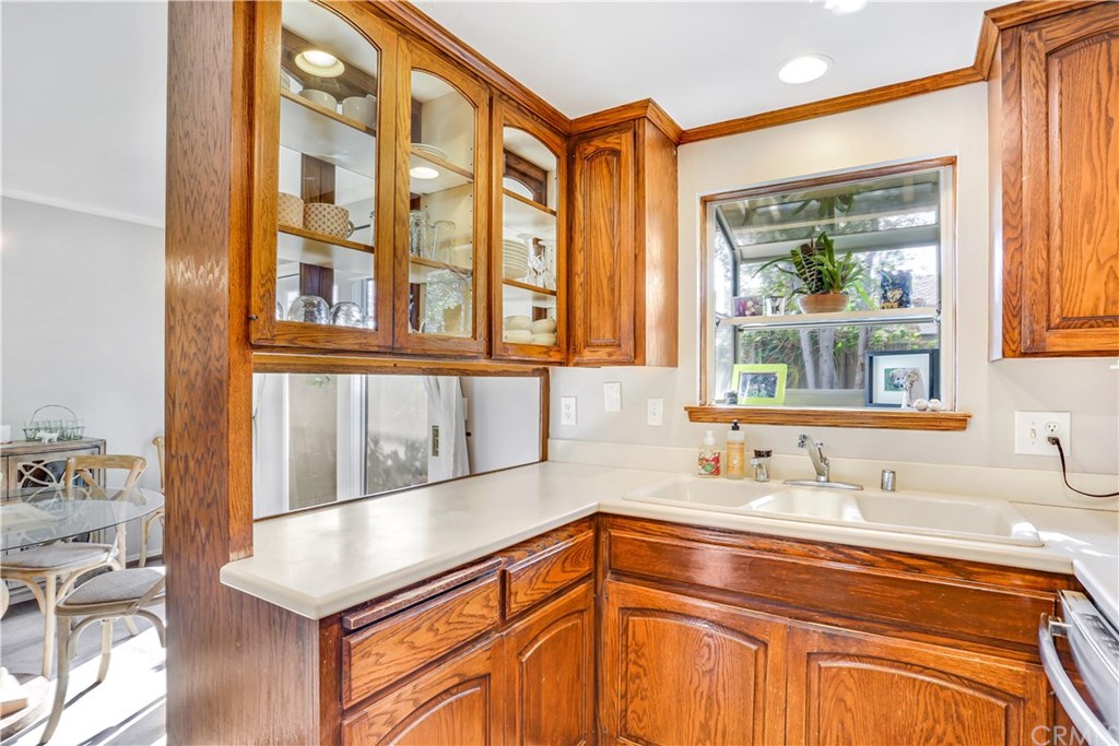 421 Gloucester Drive Costa Mesa, CA 92627 - Photo 11 of 30 Cabinets have glass doors on either side, canned lights in the ceiling.