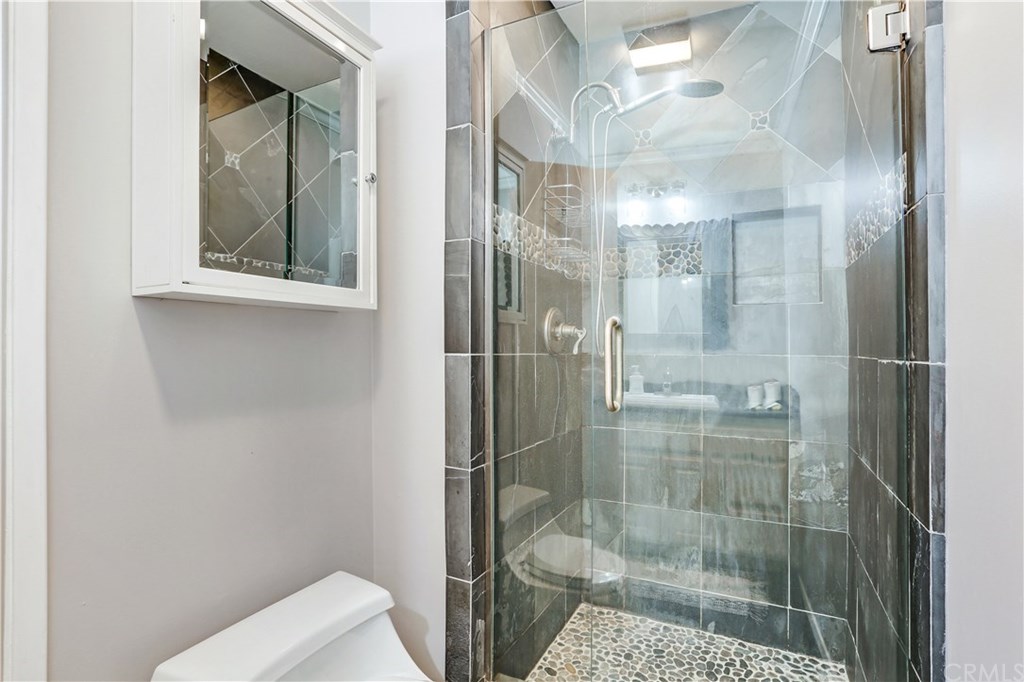 421 Gloucester Drive Costa Mesa, CA 92627 - Photo 13 of 30 Master bath features glass door shower and custom tile work.