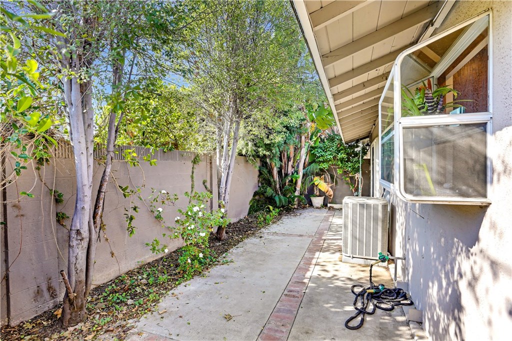 421 Gloucester Drive Costa Mesa, CA 92627 - Photo 18 of 30 Spacious rear patio with privacy and lots of trees is accessible from the dining room or guest bedroom.