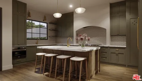 a kitchen with a sink cabinets and wooden floor