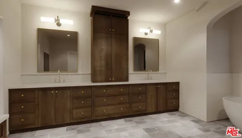 a bathroom with a granite countertop double vanity sink and a mirror