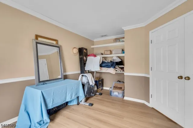 a view of a bedroom with baby and furniture