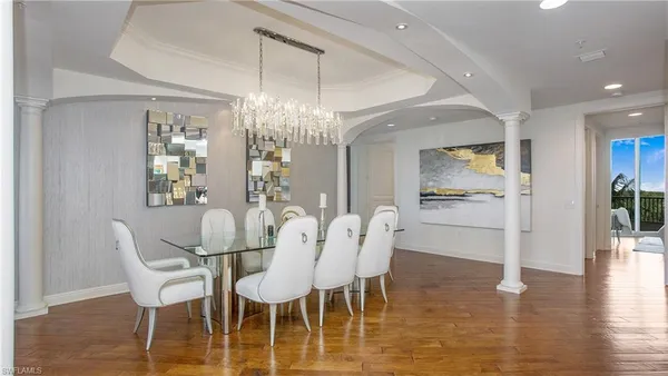 a view of a dining room with furniture wooden floor and chandelier
