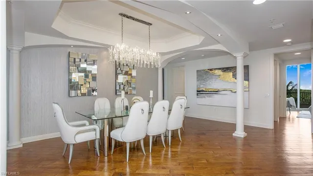 a view of a dining room with furniture wooden floor and chandelier
