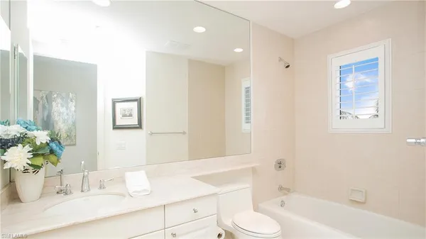 a view of a balcony with furniture and a floor to ceiling window