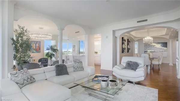 a living room with furniture and a potted plant