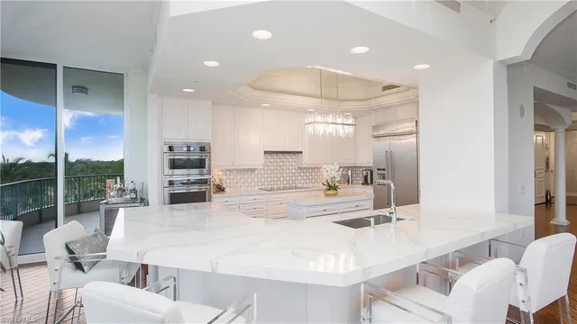 a large kitchen with a table and chairs