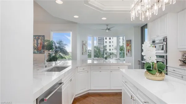 a kitchen with a sink and potted plant