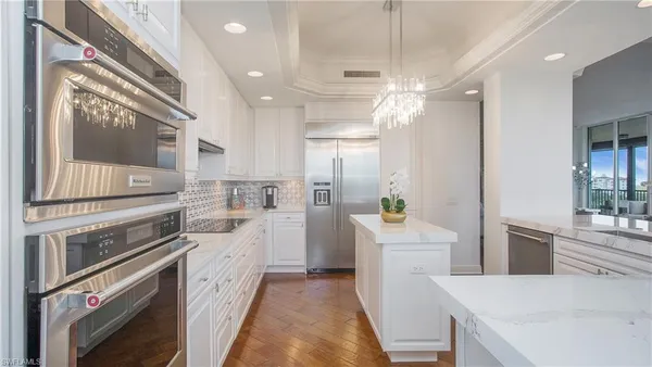 a view of a dining room with furniture and chandelier