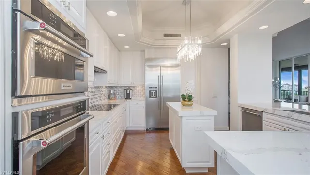 a view of a dining room with furniture and chandelier