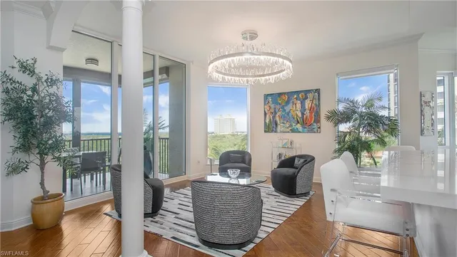 a living room with furniture a dining table and kitchen view