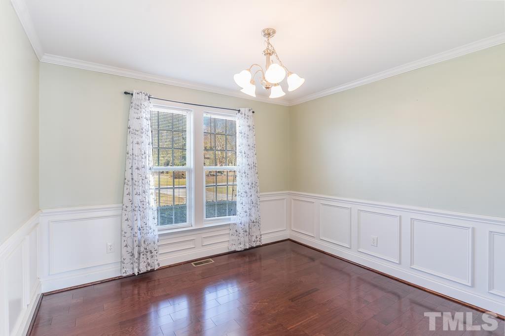 5016 Contender Drive Raleigh, NC 27603 - Photo 13 of 29 an empty room with wooden floor and windows