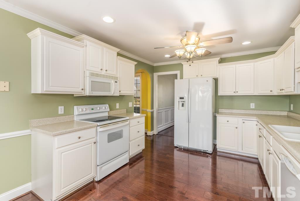 5016 Contender Drive Raleigh, NC 27603 - Photo 16 of 29 a kitchen with a white cabinets and white appliances