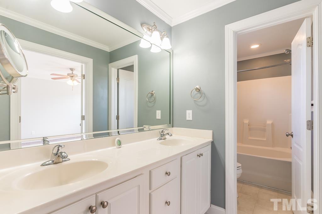 5016 Contender Drive Raleigh, NC 27603 - Photo 22 of 29 a bathroom with a sink double vanity and a mirror