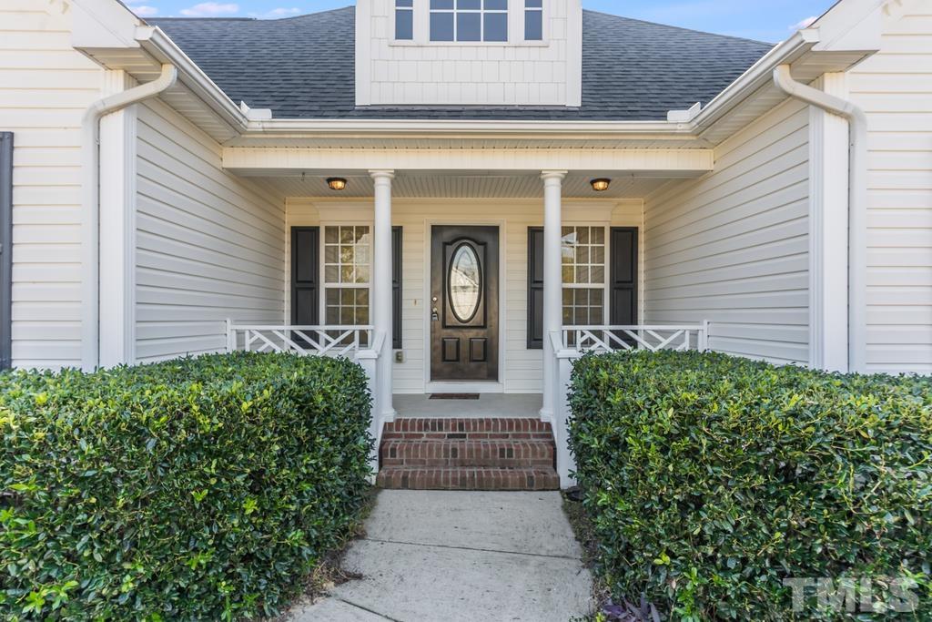 5016 Contender Drive Raleigh, NC 27603 - Photo 4 of 29 a front view of a house with garden