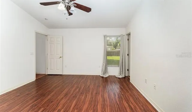 wooden floor in an empty room with a window