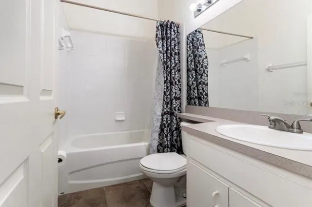 a bathroom with a toilet a sink and a bathtub
