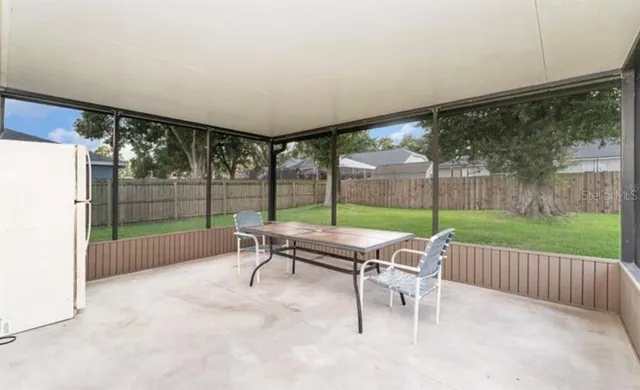 a building outdoor space with patio furniture and garden