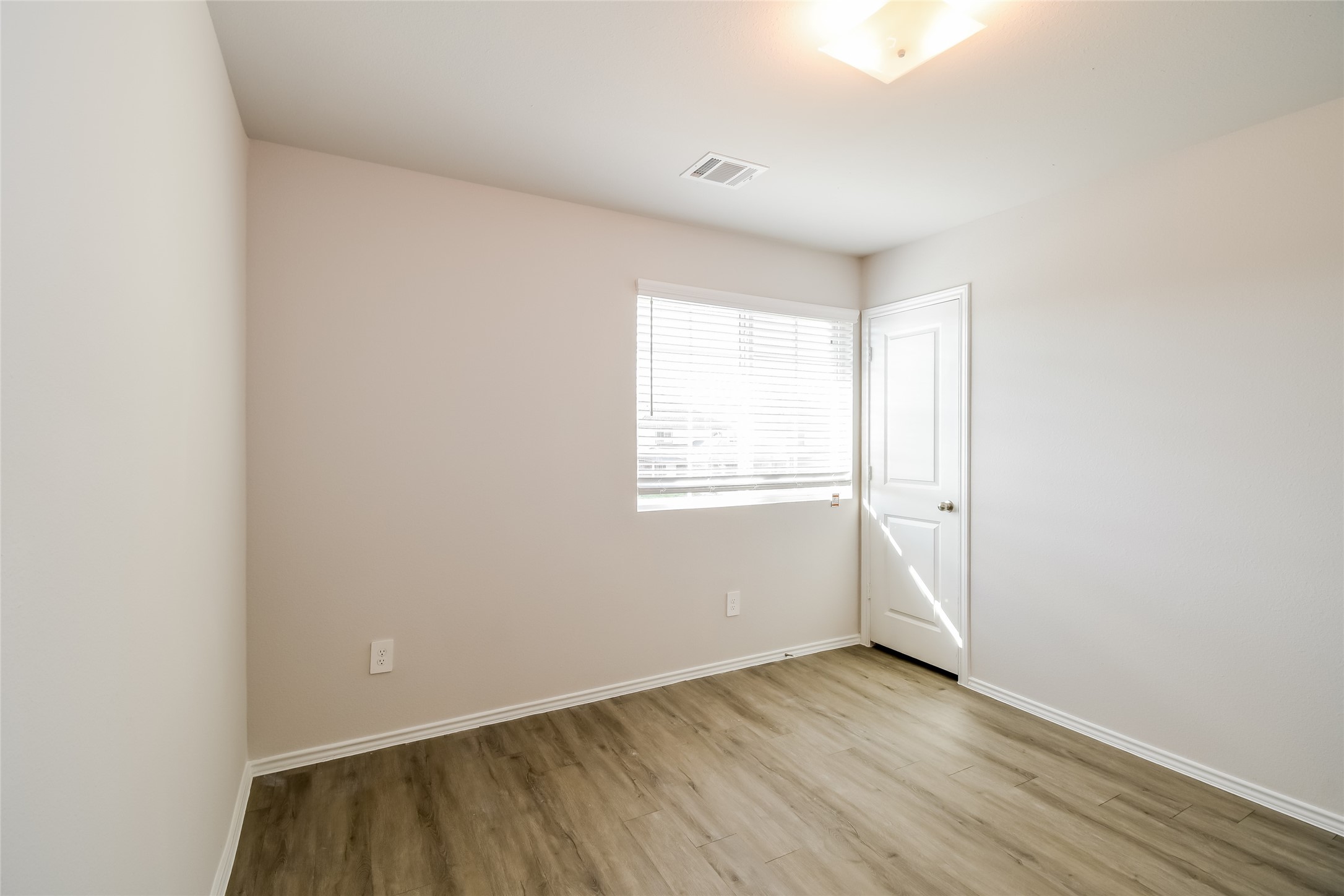 4931 Giant Sequoia Way Spring, TX 77373 - Photo 11 of 16 a view of an empty room with wooden floor and a window