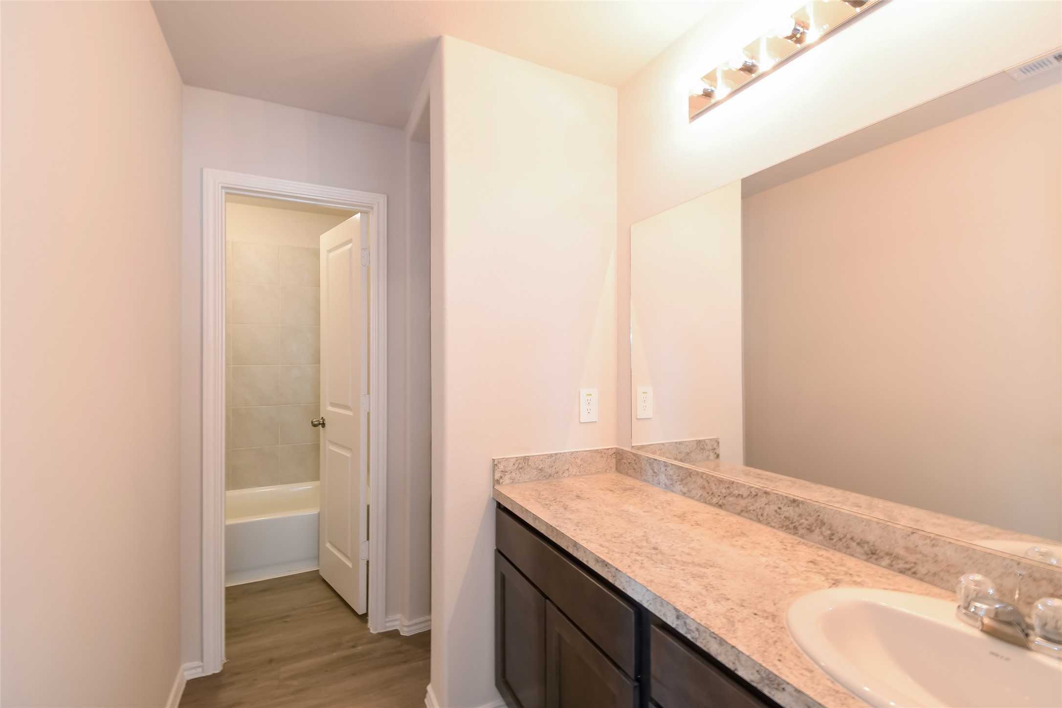 4931 Giant Sequoia Way Spring, TX 77373 - Photo 13 of 16 a bathroom with a granite countertop sink and a mirror