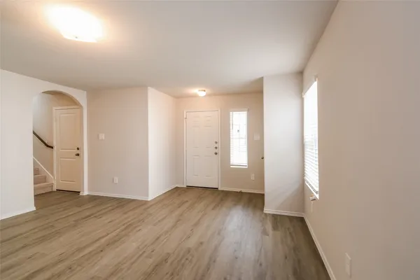 wooden floor in an empty room with a window