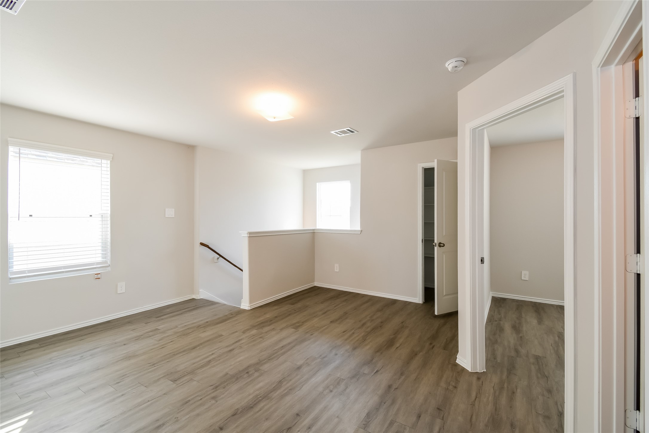 4931 Giant Sequoia Way Spring, TX 77373 - Photo 5 of 16 an empty room with wooden floor and windows