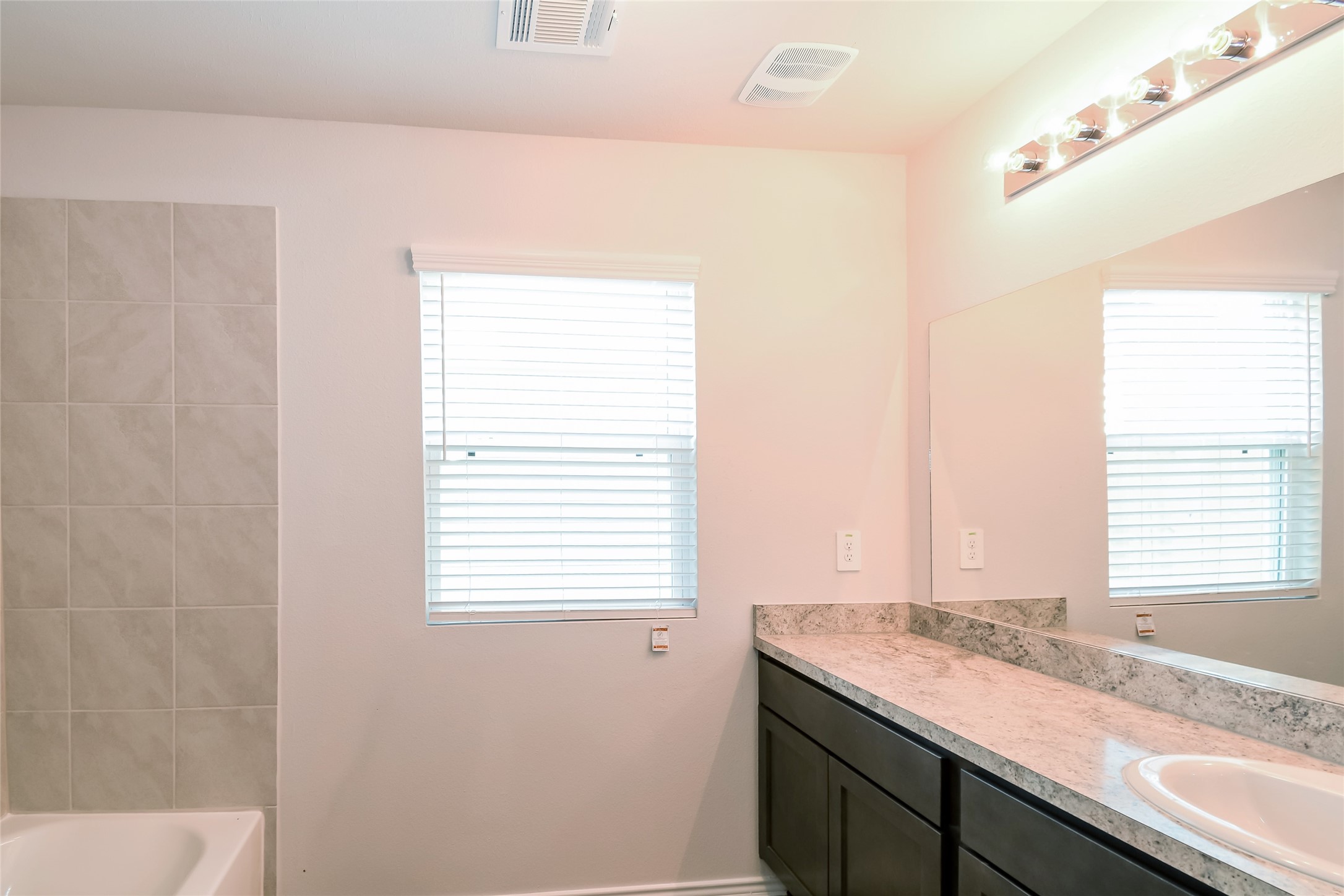 4931 Giant Sequoia Way Spring, TX 77373 - Photo 8 of 16 a bathroom with a granite countertop sink and a window