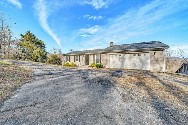 a living room with furniture a clock and a window