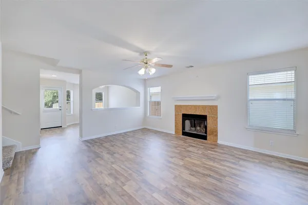 wooden floor in an empty room with a chandelier