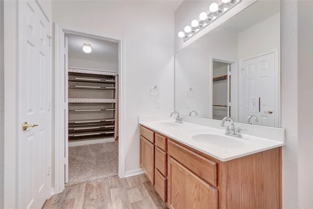 a bathroom with a sink double vanity and a mirror