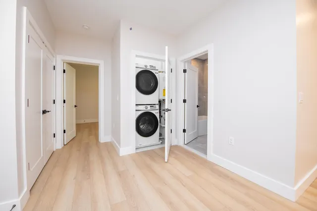 a view of a hallway with washer and dryer