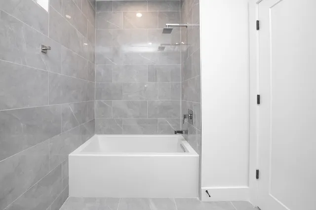 a white bath tub sitting next to a white sink
