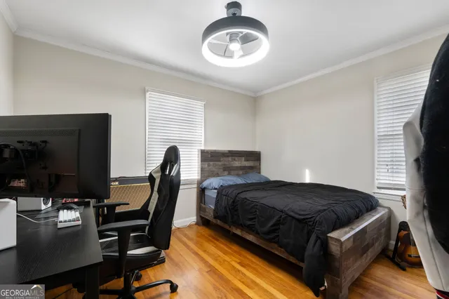 a bedroom with a bed window and chair