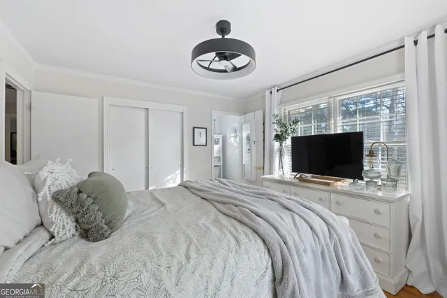 a bedroom with a bed and a flat screen tv