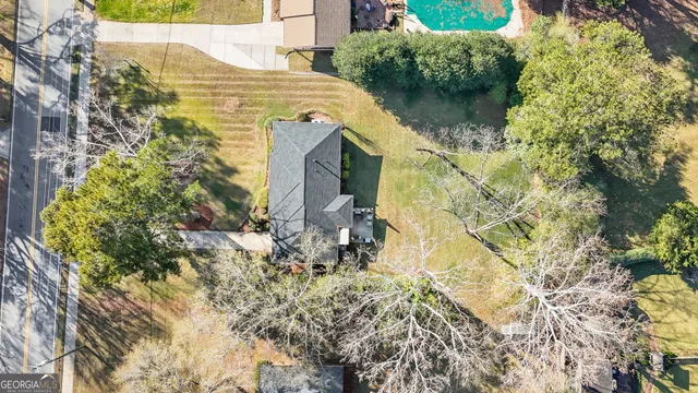 a aerial view of residential house with pool and garden