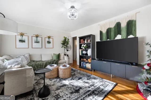 a living room with furniture and a flat screen tv