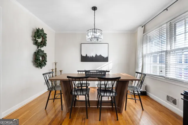 a view of a dining room with furniture window and wooden floor