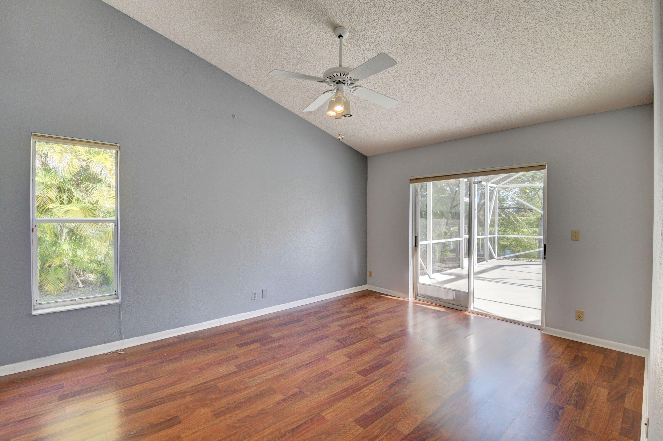 12059 Rockwell Way Boca Raton, FL 33428 - Photo 18 of 28 a view of an empty room with wooden floor and a window