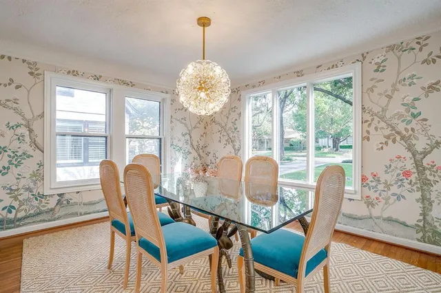 a view of a dining room with furniture wooden floor and a chandelier