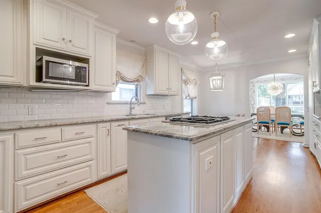a kitchen with stainless steel appliances granite countertop a stove and a sink
