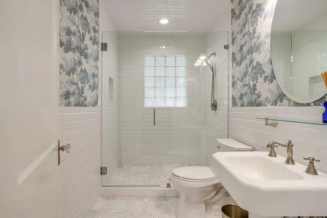 a bathroom with a sink toilet and shower