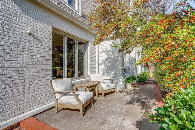 a view of a patio with table and chairs and potted plants
