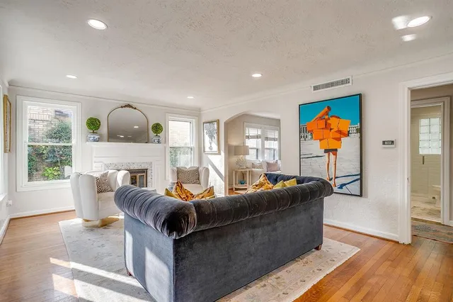 a living room with fireplace furniture and a large window