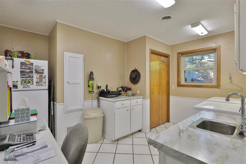 604 North 19th Street Haskell, TX 79521 - Photo 15 of 36 a kitchen with a sink appliances and cabinets