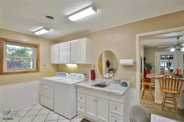 a kitchen with granite countertop a stove a sink and a refrigerator