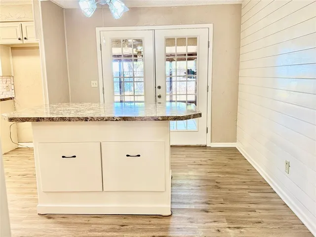 a view of a kitchen with granite countertop cabinets and wooden floor