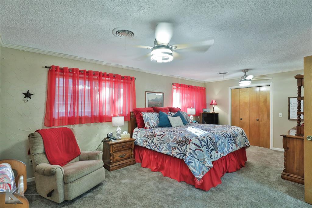 604 North 19th Street Haskell, TX 79521 - Photo 22 of 36 a bedroom with a bed and a couch