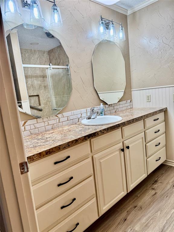 604 North 19th Street Haskell, TX 79521 - Photo 23 of 36 a bathroom with a granite countertop double vanity sink and mirror