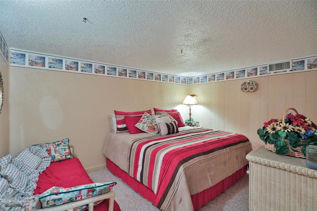 604 North 19th Street Haskell, TX 79521 - Photo 26 of 36 a bedroom with a bed and a potted plant