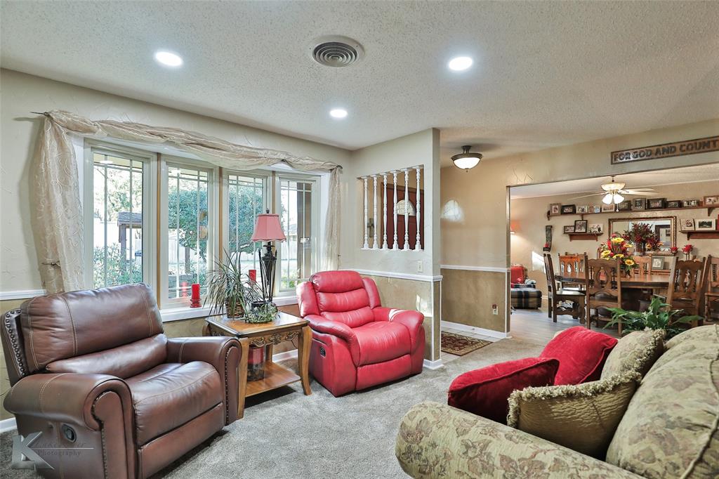 604 North 19th Street Haskell, TX 79521 - Photo 5 of 36 a living room with furniture and a floor to ceiling window